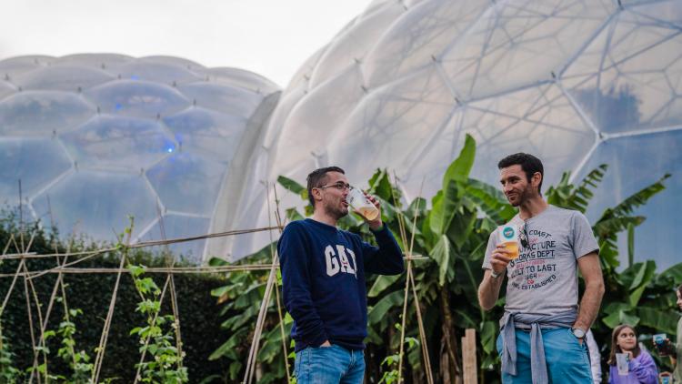 Friends enjoying drink at Eden Sessions with Biomes in background
