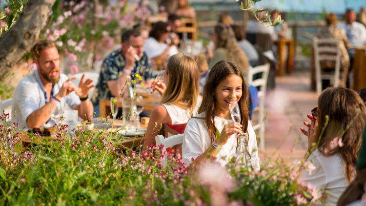 People having sit down Mediterranean style meals